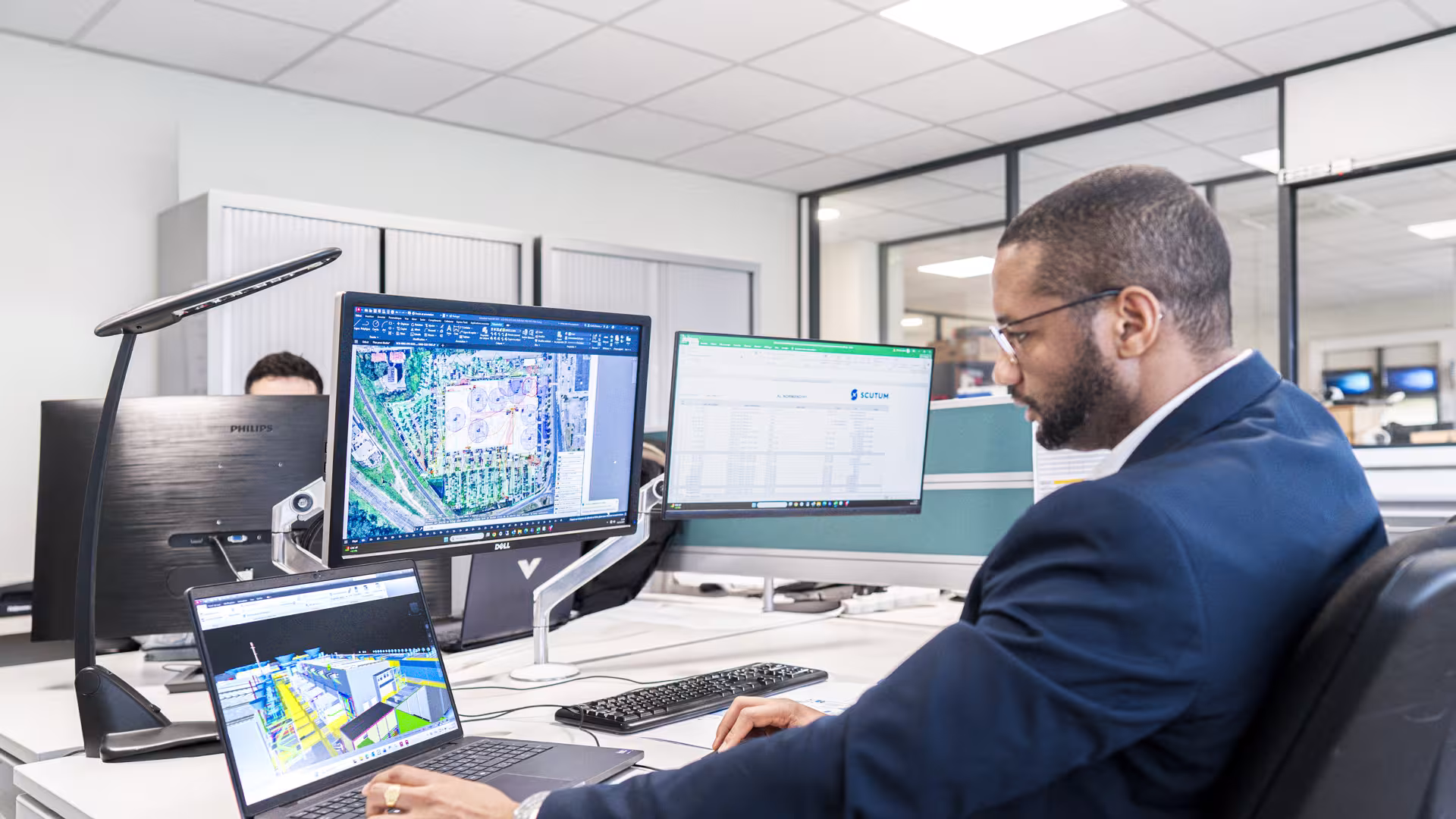 Scutum employee working working on plans on computer