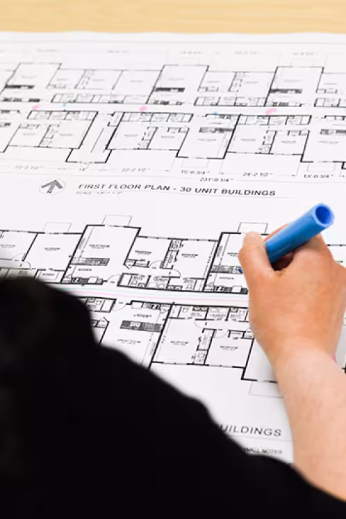 Woman working on fire alarm building plans