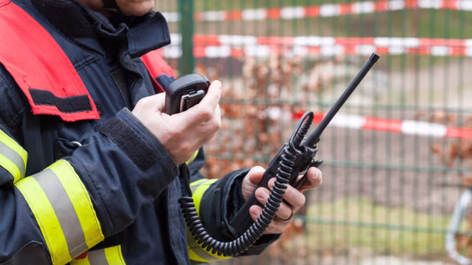 ERRCS system with emergency responder holding radio