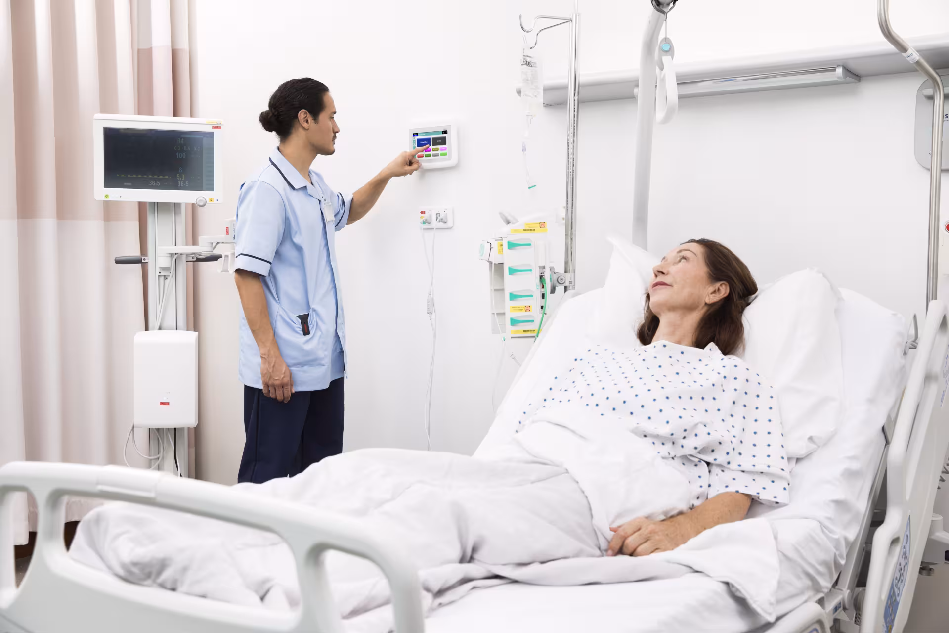 Nurse at bedside nurse call station