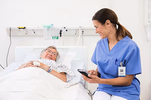 Ascom Myco mobile phone for nurse call with nurse at patient bedside